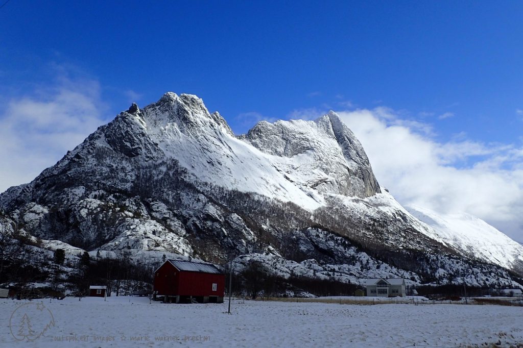 The mountain peak at Strandaa, Kjerringøy, Norway. grey rock with snow. House foreground