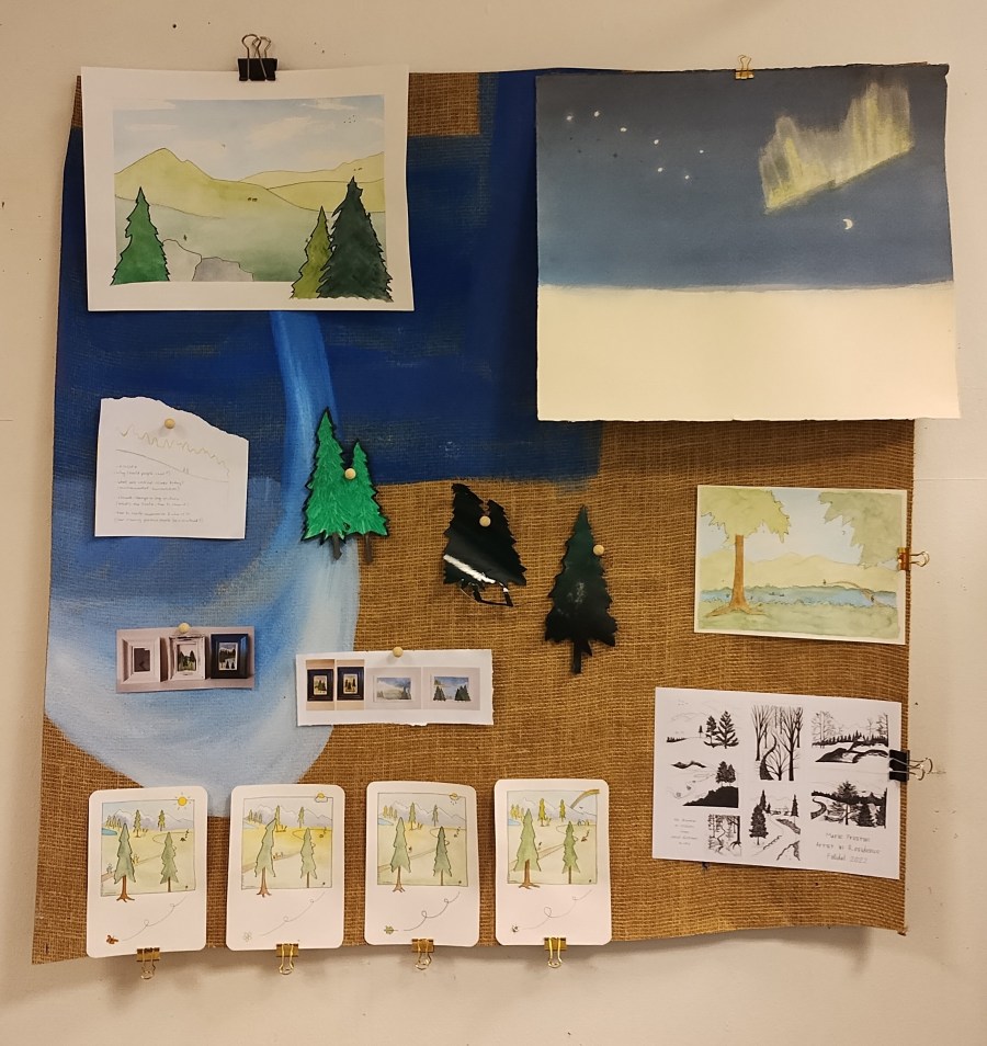 comics, trees, landscapes and watercolour paintings stuck to corkboard
